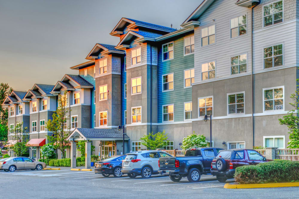 View of parking area with building in the background at The Creekside in Woodinville, Washington