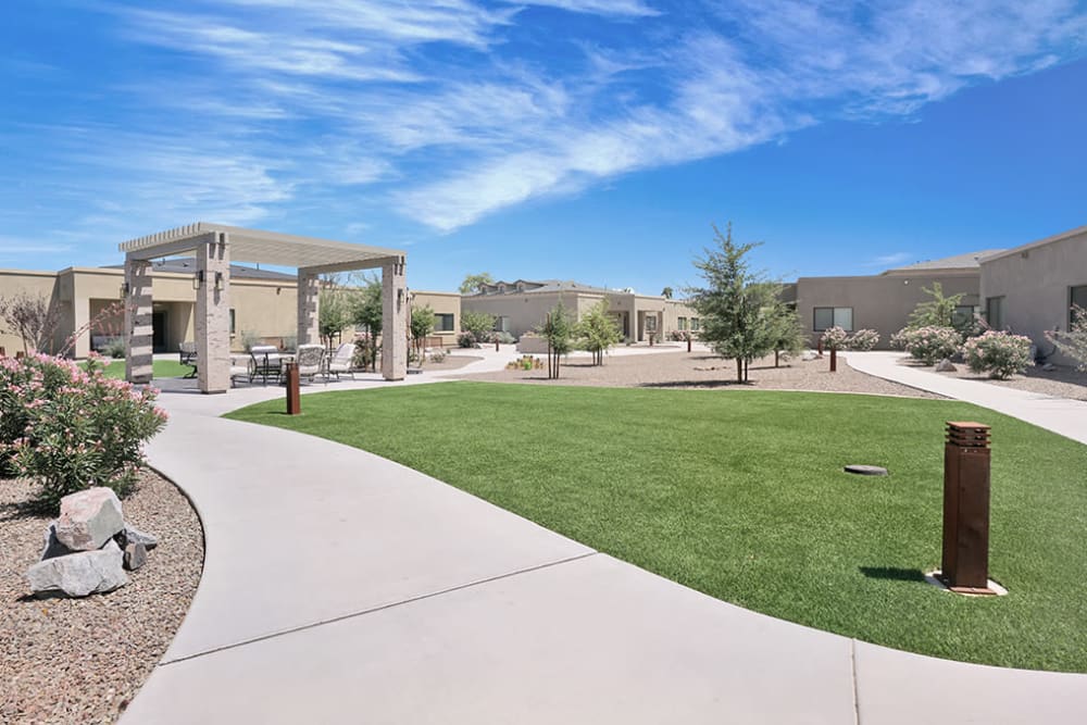 Paved walking areas surrounding a small grassy area at Hacienda Del Rey in Litchfield Park, Arizona