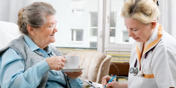 Resident having tea while going over care plan at East Troy Manor in East Troy, Wisconsin