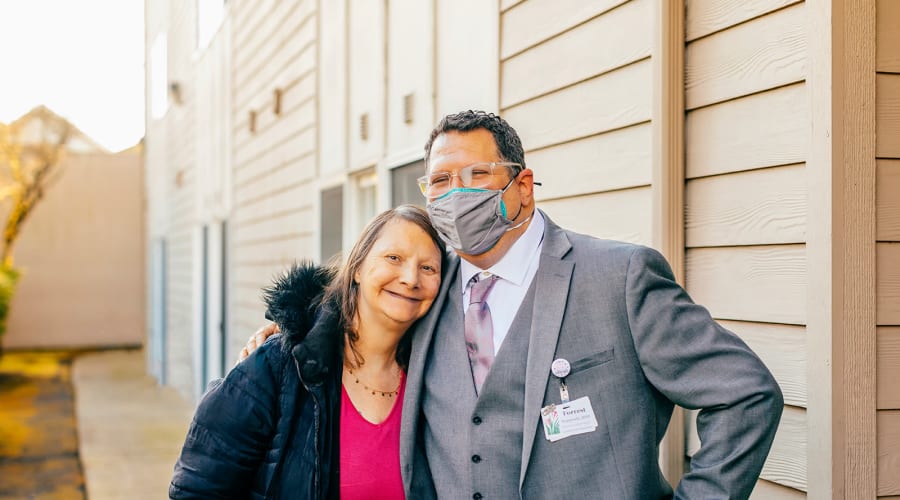 Happy resident and caregiver smiling for a photo at Cascade Park Gardens Memory Care in Tacoma, Washington