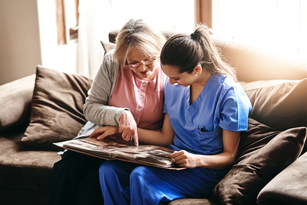 Resident reading with a nurse at Regency Gresham Nursing and Rehabilitation Center in Gresham, Oregon