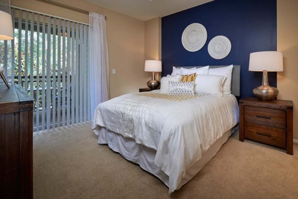 Spacious bedroom with wall art at Legend Oaks Apartments in Aurora, Colorado