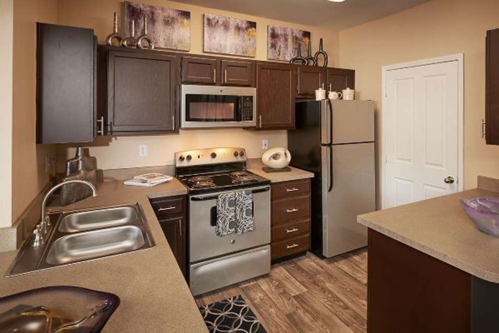 Kitchen with updated interiors at Legend Oaks Apartments in Aurora, Colorado