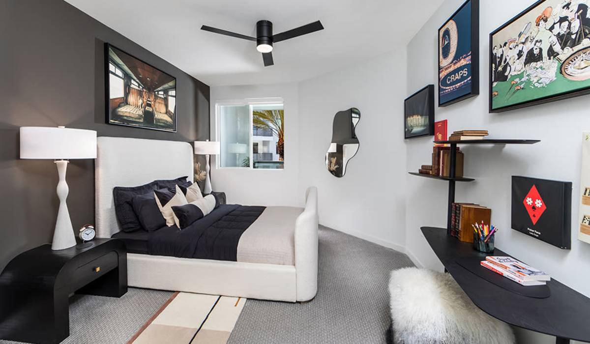 Well-furnished apartment bedroom with ceiling fan at The Ellison in Las Vegas, Nevada