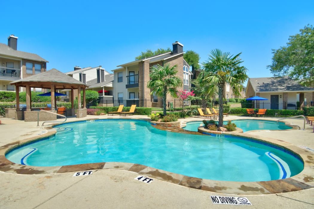 Gorgeous swimming pool area on a beautiful day at Ridgeview Place in Irving, Texas