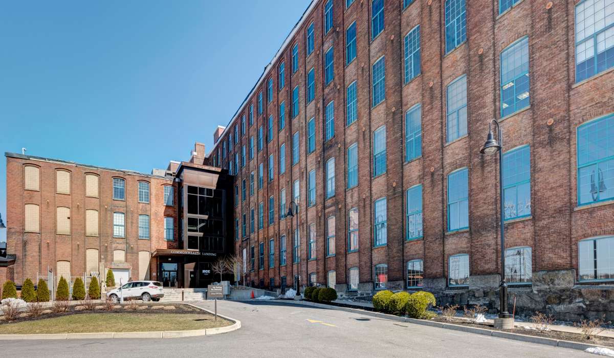 Luxury brick building with large windows at Commonwealth Landing Lofts in Fall River, Massachusetts