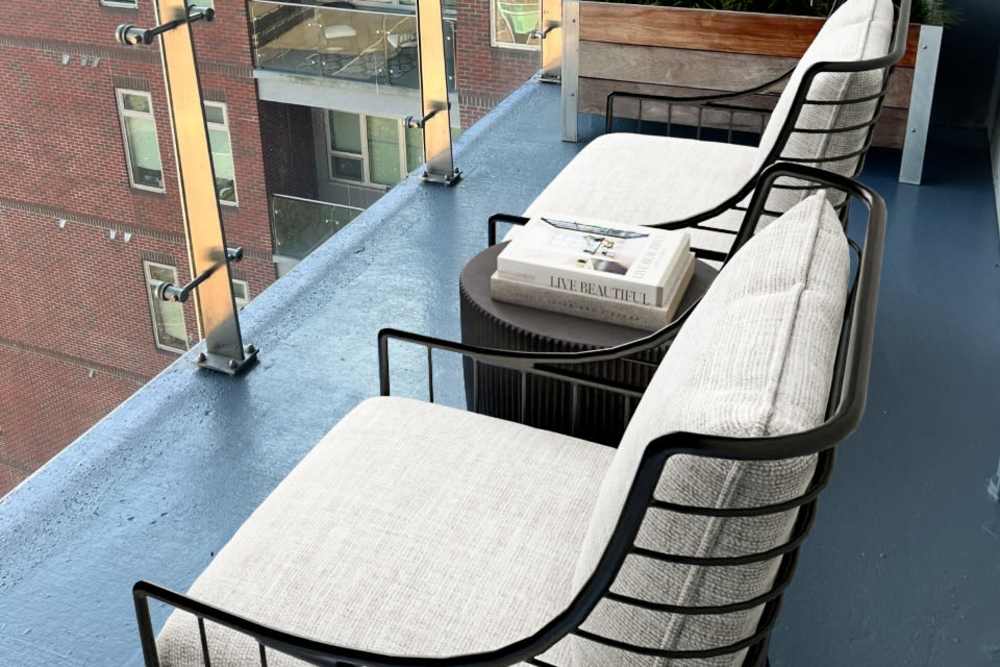 Relaxing balcony space with furniture at Terraces at Manchester in Richmond, Virginia