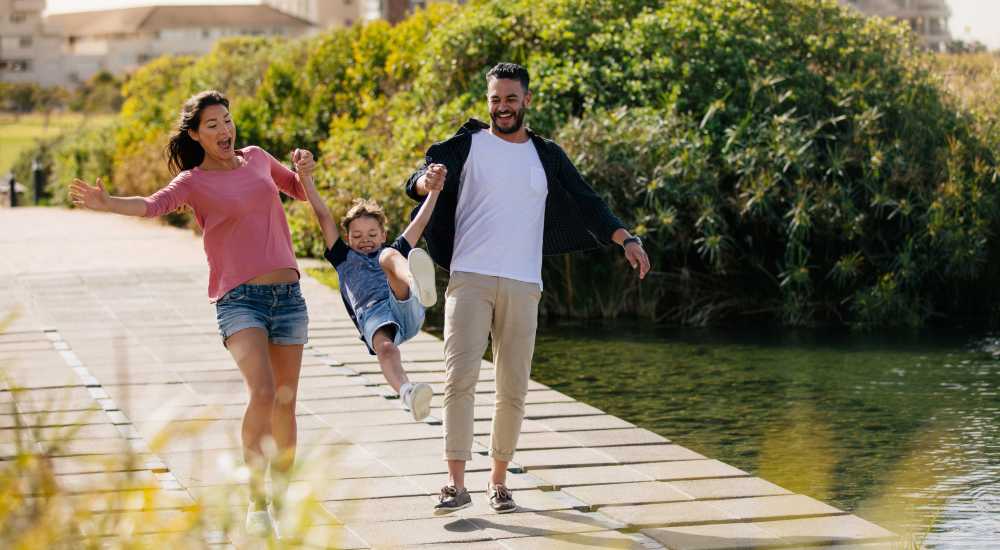 Resident family having fun near lake at Millennium Place in Corinth, Texas