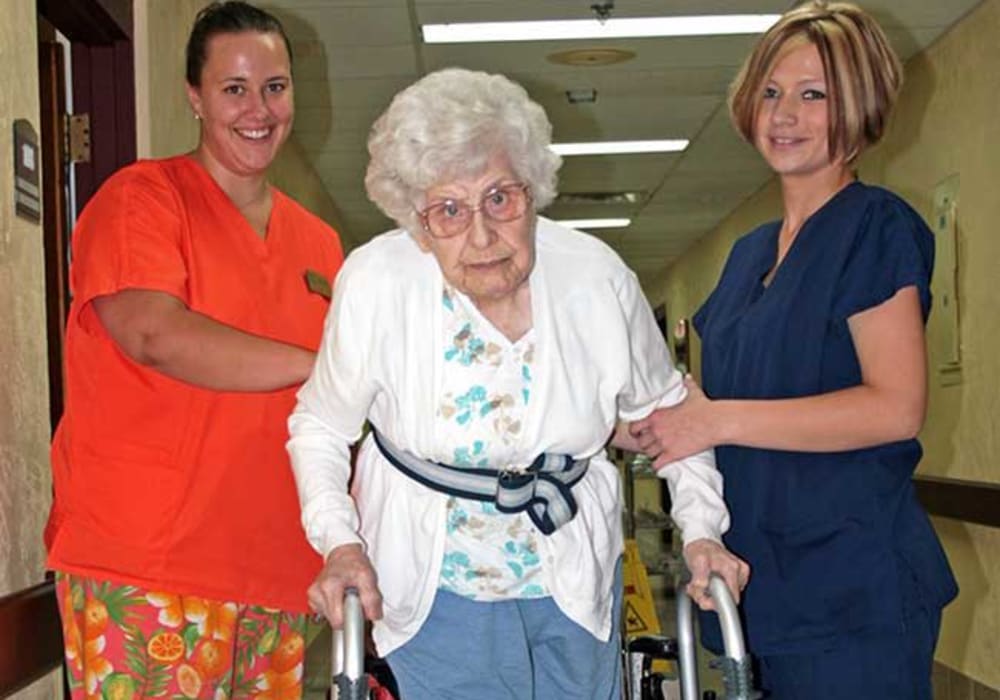 Resident receiving assistance with walking to their room at Montello Care Center in Montello, Wisconsin