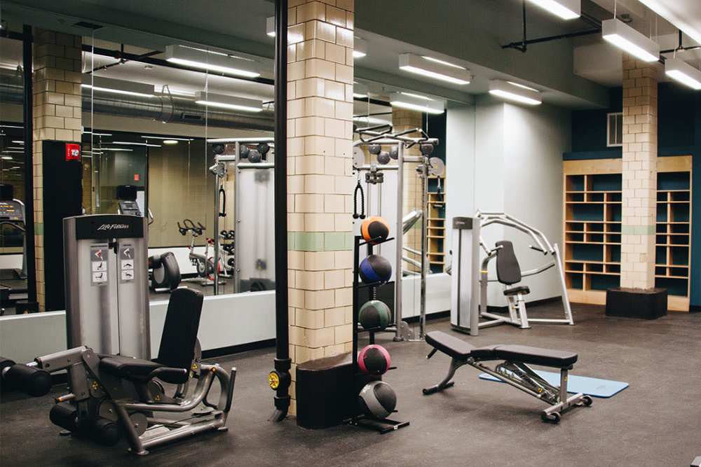 Fully-equipped fitness center with modern equipment at Courtyard Lofts at Scott’s Addition in Richmond, Virginia