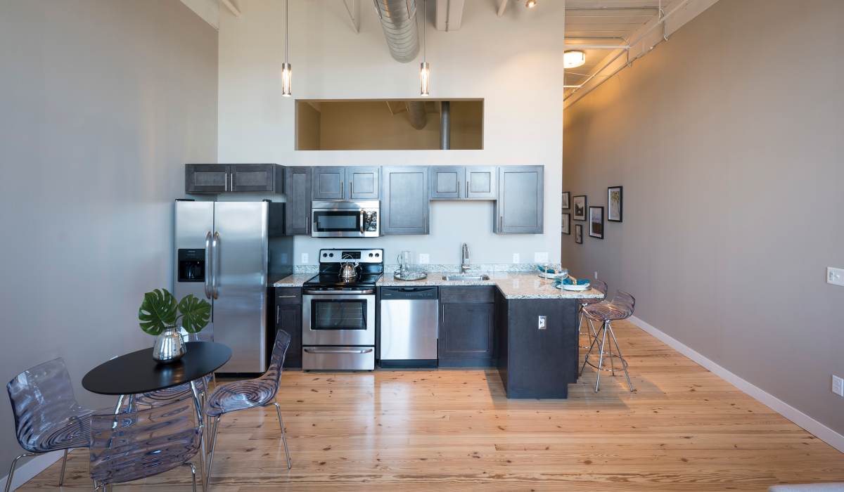 Luxury kitchen with stainless steel appliances and granite at Commonwealth Landing Lofts in Fall River, Massachusetts