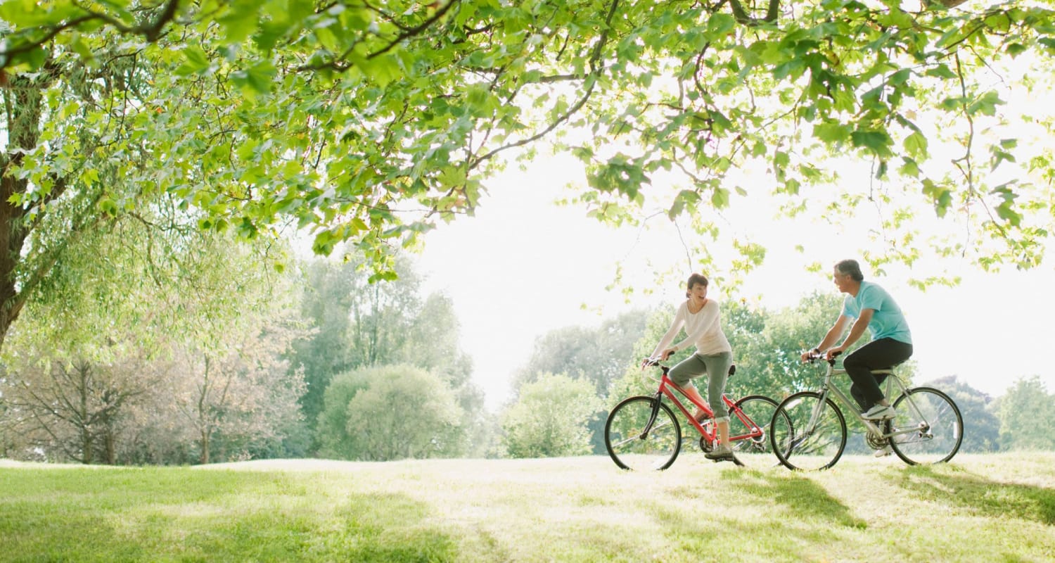 Residents riding their bikes in a park near The Park at Aventino in Greensboro, North Carolina