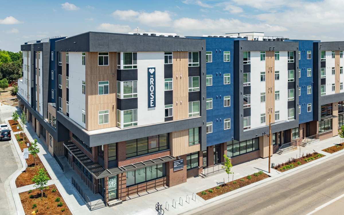 Building exterior with signage at The Rose on Colfax in Denver, Colorado