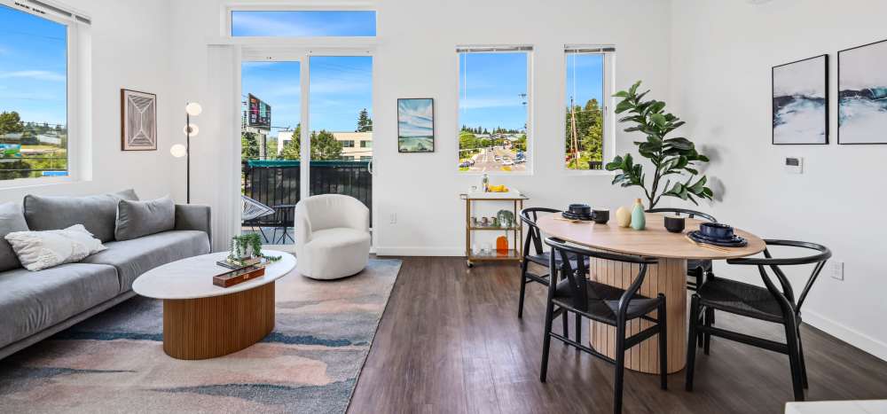 Furnished living room with wooden flooring and access to the patio at Allegro in Lynnwood, Washington 