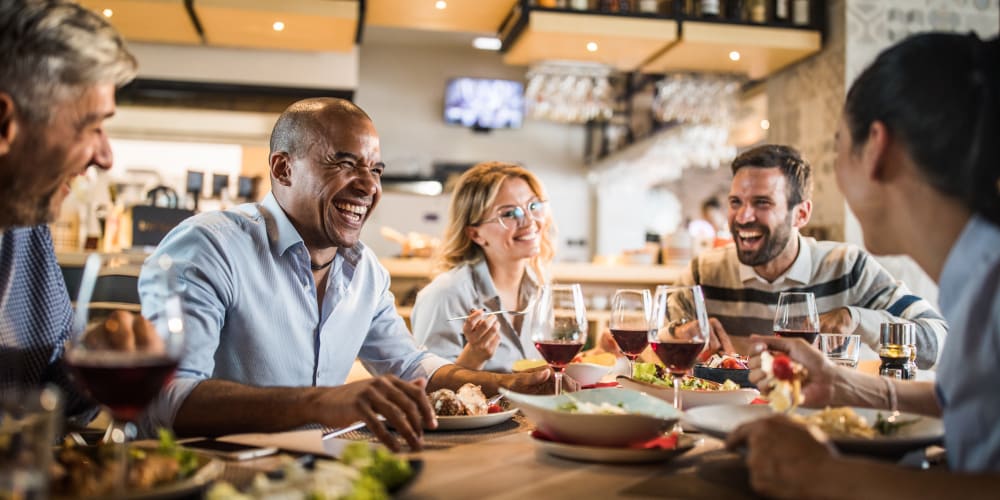 A group of friends sitting at a table in a restaurant near River Forest in Chester, Virginia