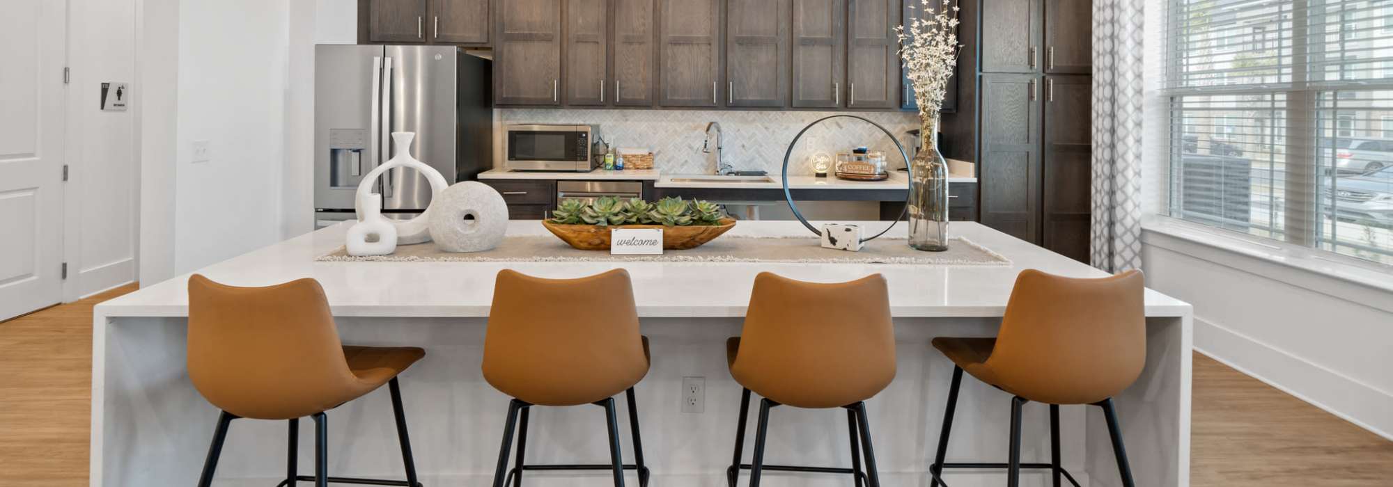 View of the kitchen in the clubhouse with bar stools at Fletcher Black in Panama City, Florida