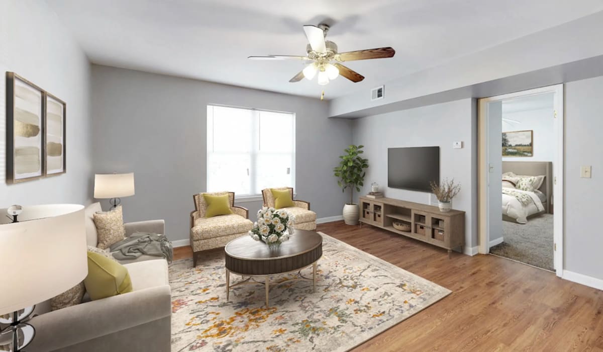 Spacious living room with couch, chair and windows at Alston Arms Apartments in North Charleston, SC