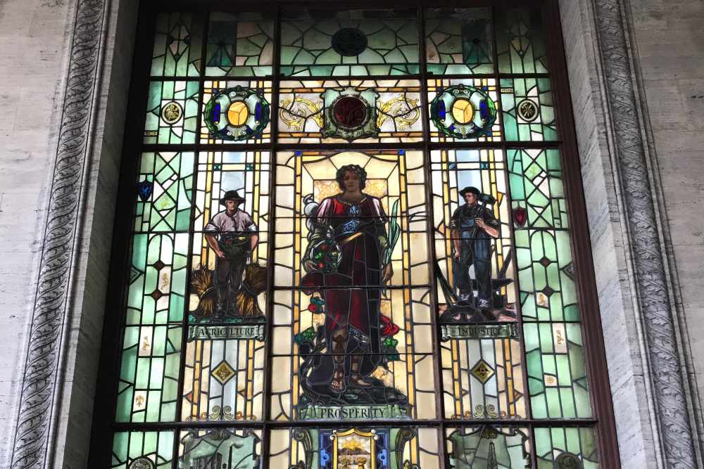 Stained glass window featuring three figures representing agriculture at 43 Town Square in Lima, Ohio