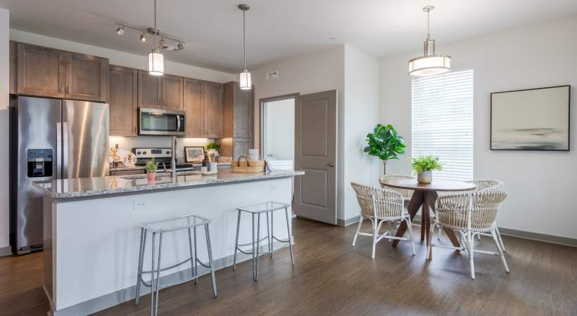 Open concept of a modern kitchen and dining area at The Banks at West Fork in Murfreesboro, Tennessee