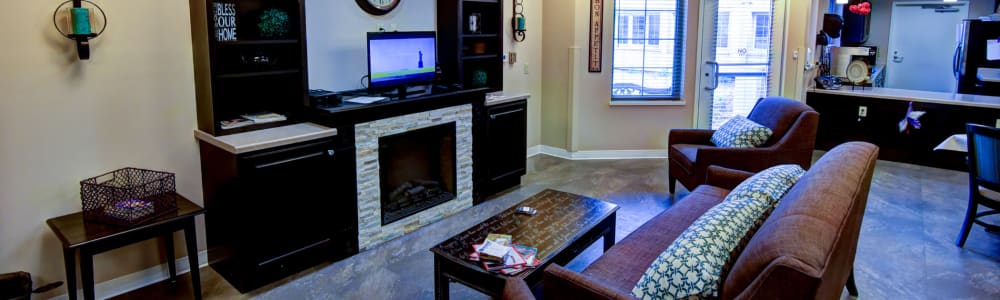 Resident common area with fireplace and tv at Holton Manor in Elkhorn, Wisconsin