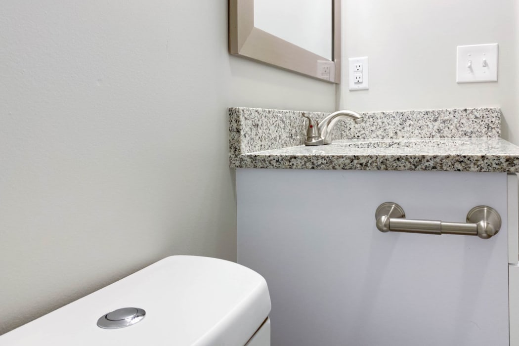 Bathroom with granite counters at The Hills at Oakwood Apartment Homes in Chattanooga, Tennessee