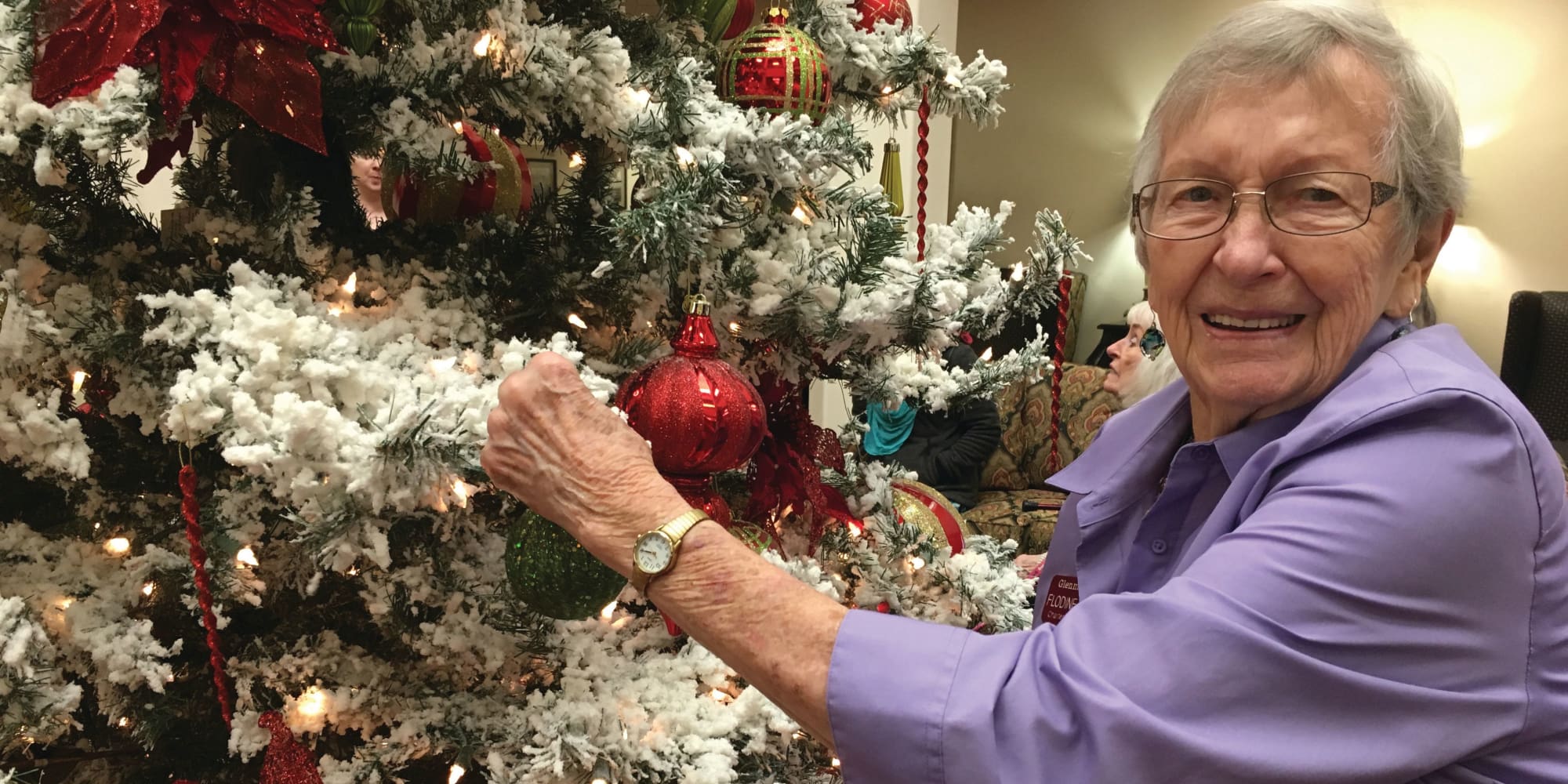 A resident decorating a tree at Mulberry Gardens Memory Care in Munroe Falls, Ohio