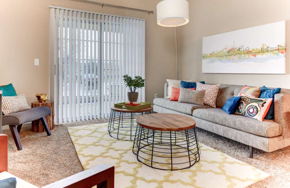 Living room with chair, coffee table and wall art at The Bradford at Easton Apartments & Townhomes in Columbus, Ohio