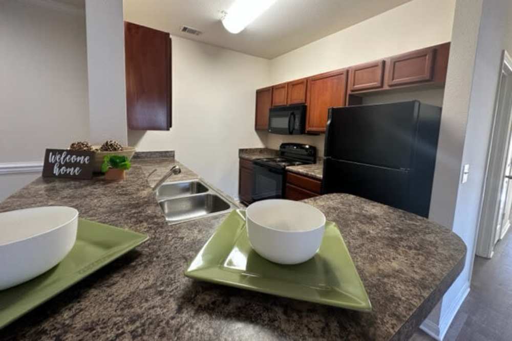 Fully equipped kitchen with appliances and connecting dining space at Preserve at Windsor Lake in Columbia, South Carolina