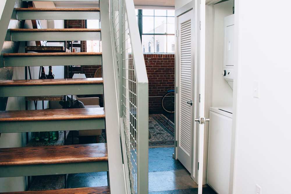 Stairs leading to open living area at Courtyard Lofts at Scott’s Addition in Richmond, Virginia