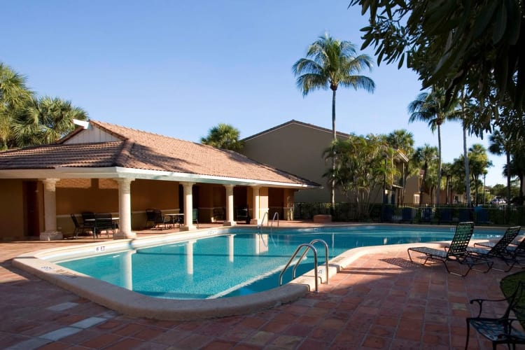 Resort-style swimming pool and poolside gazebo at Executive Apartments in Miami Lakes, Florida