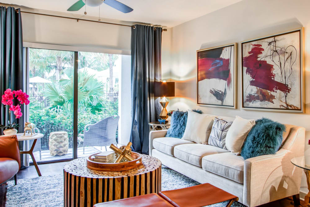 Beautifully decorated model living room opening onto a private balcony at Luzano in Pompano Beach, Florida