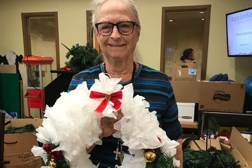 Resident with wreath she made at Edencrest at Green Meadows in Johnston, Iowa