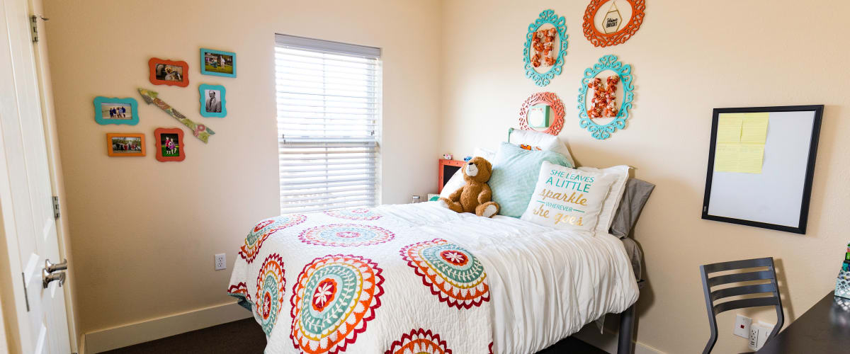 A bedroom with a window to let in natural light at Beacon Springfield in Springfield, Missouri