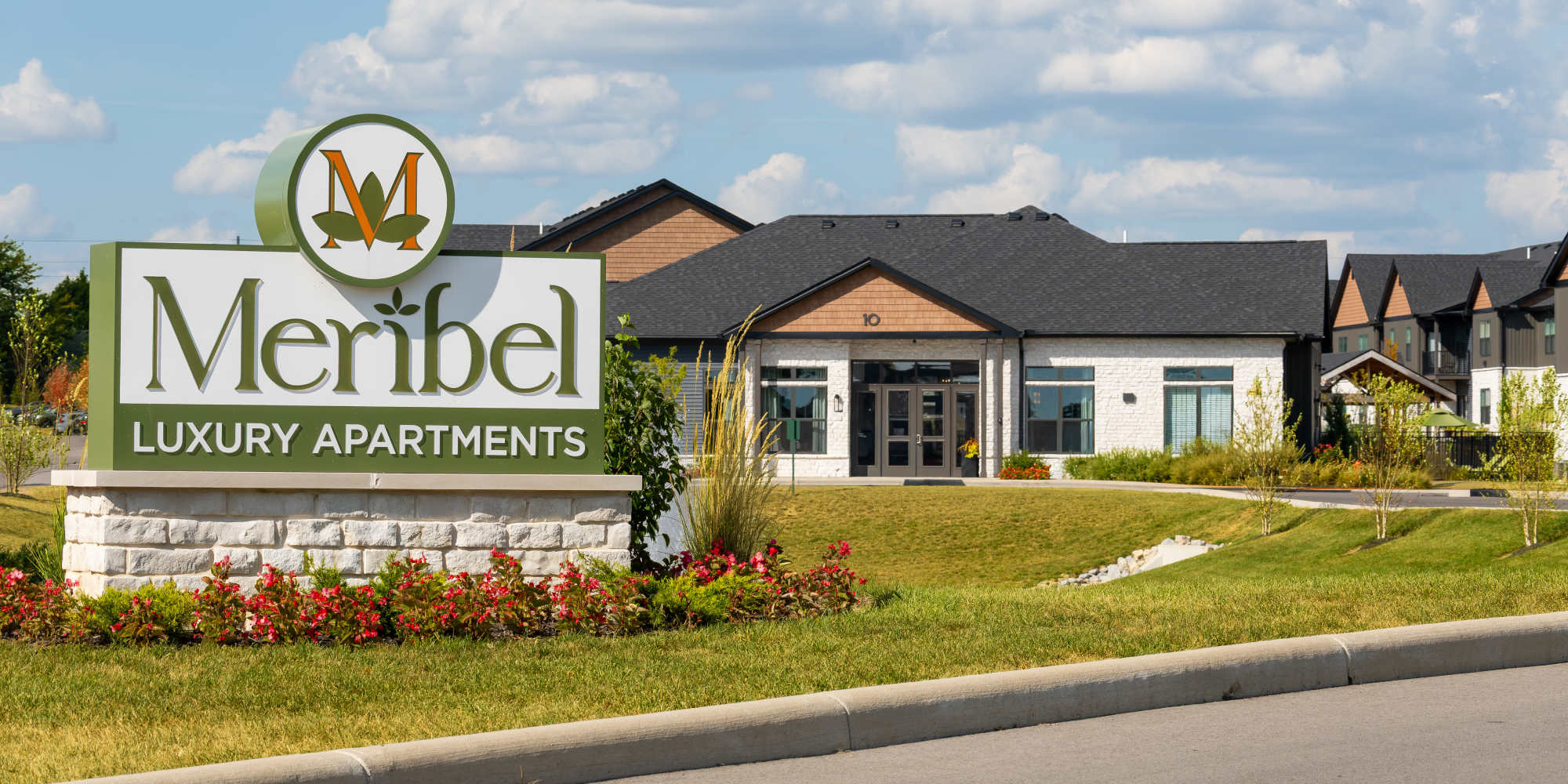 Meribel Luxury Apartments entrance sign and leasing office exterior at Meribel in Springboro, Ohio