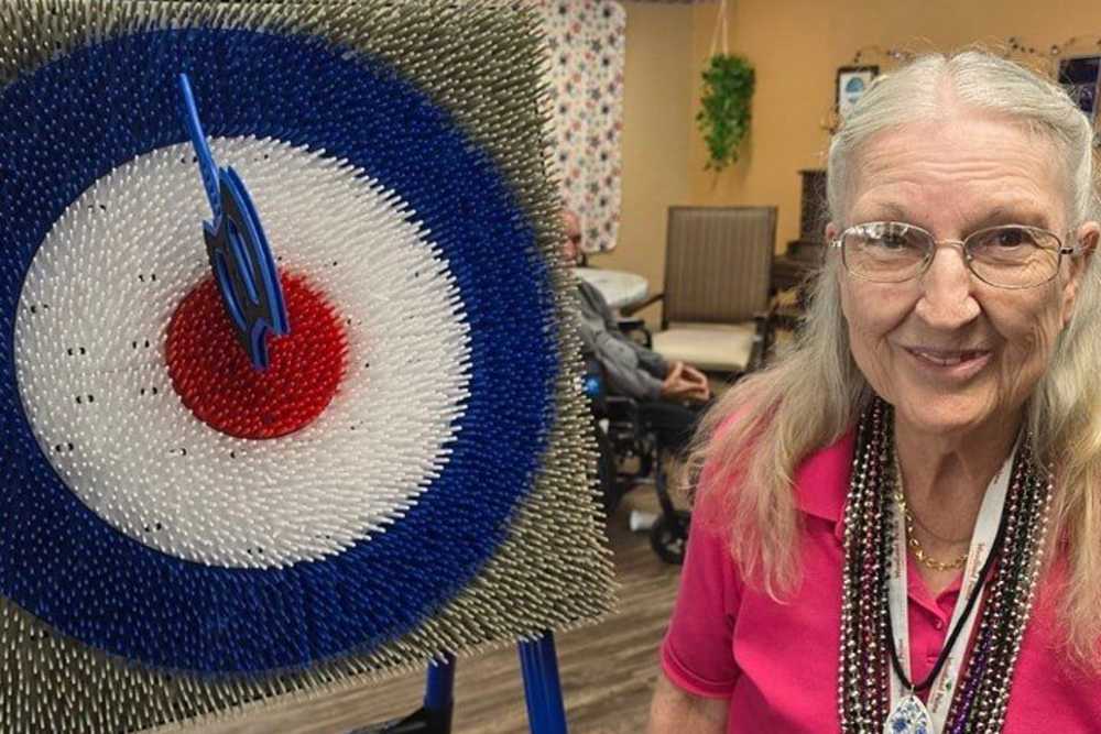 Woman hit bulls eye on the target at Woodland Palms Memory Care in Tucson, Arizona