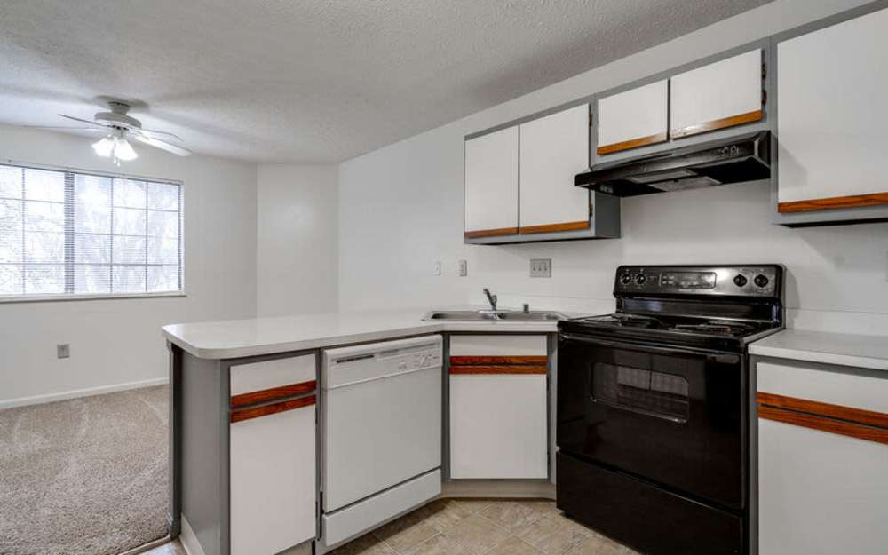 Modern apartment kitchen with full appliance package at Carriage Court in Cincinnati, Ohio