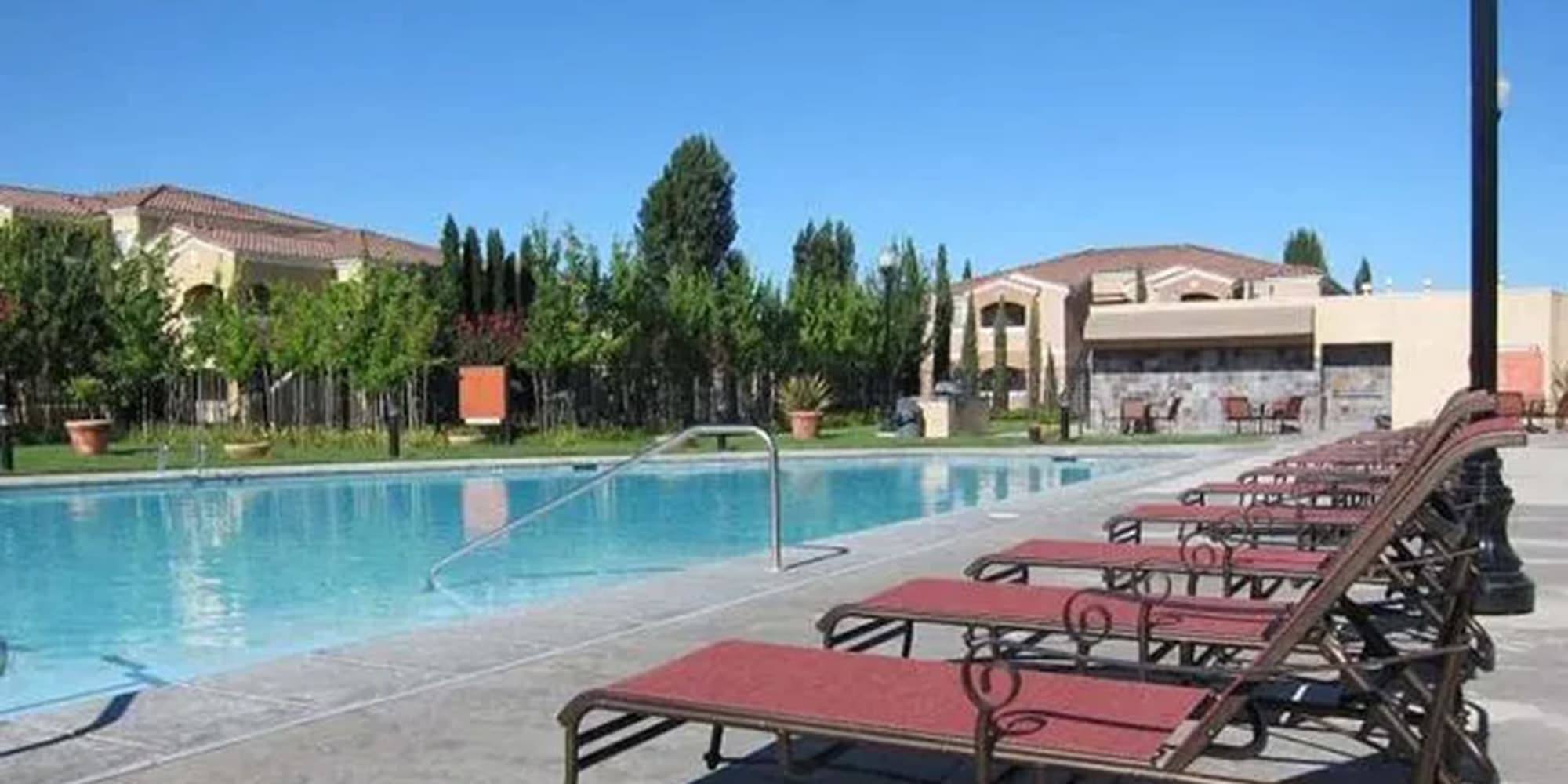 Swimming pool with outdoor seating at  Siena Villas Apartments in Elk Grove, California