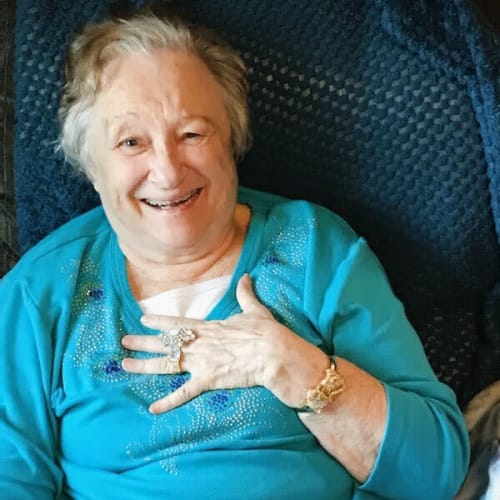 Resident smiling and looking up at Glen Carr House Memory Care in Derby, Kansas