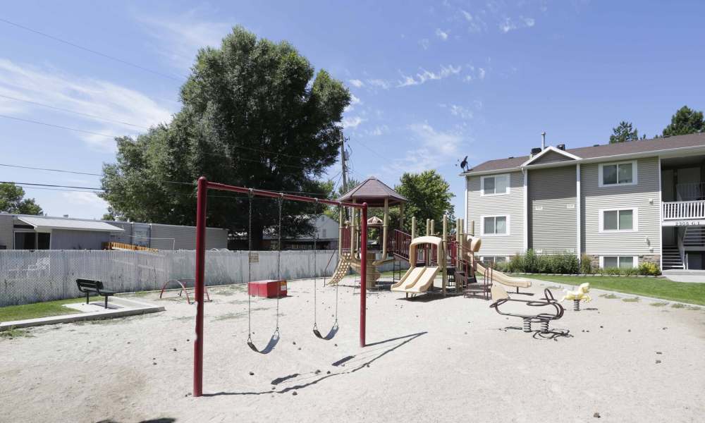 A swing set and playground at Valley Park Apartments in West Valley City, Utah