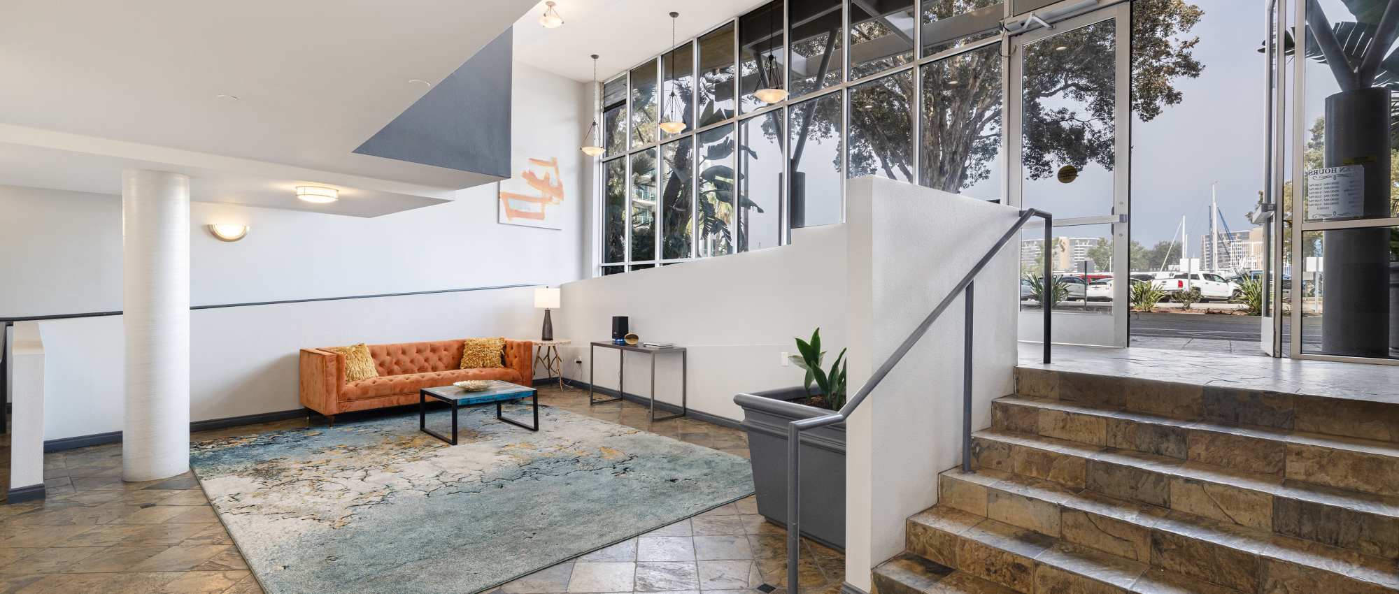 Orange couch with decorative pillows at St Tropez Apartments in Marina Del Rey, California