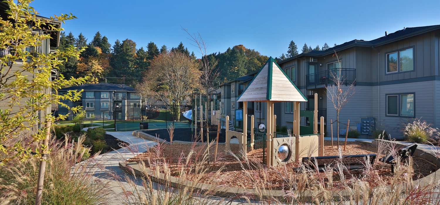 Playground area with climbing structure near apartments at Columbia View in Vancouver, Washington