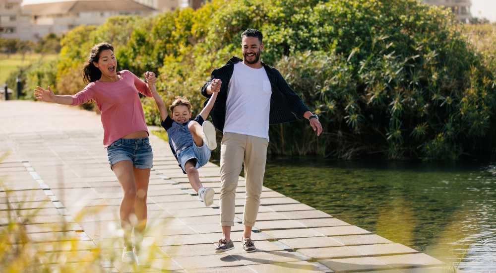 Resident family enjoying near the lake at Midtown Square Chattanooga Apartments in Chattanooga, Tennessee