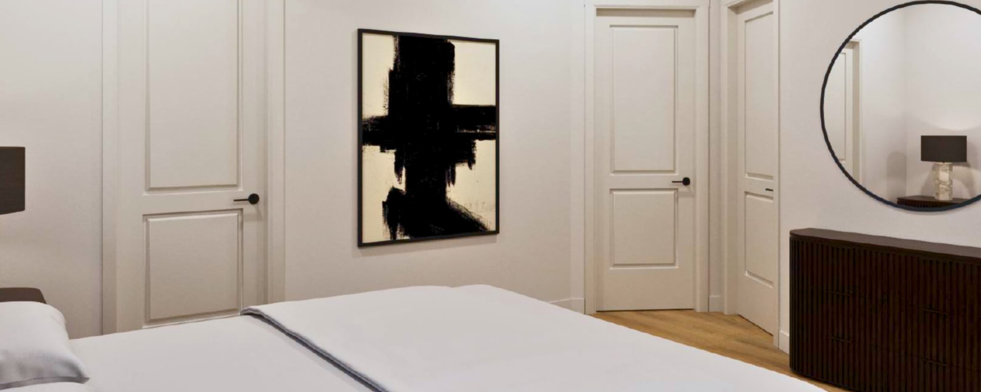 Bedroom with large bed and wood-style flooring at Two West End in Charlotte, North Carolina