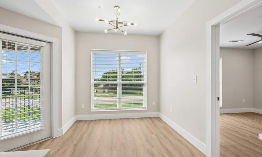 Bright living room with a large window at Lake Meadows in Garland, Texas