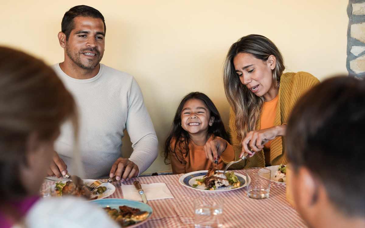 Happy resident family dining at Franklin Manor Apartments in Saint Helens, Oregon
