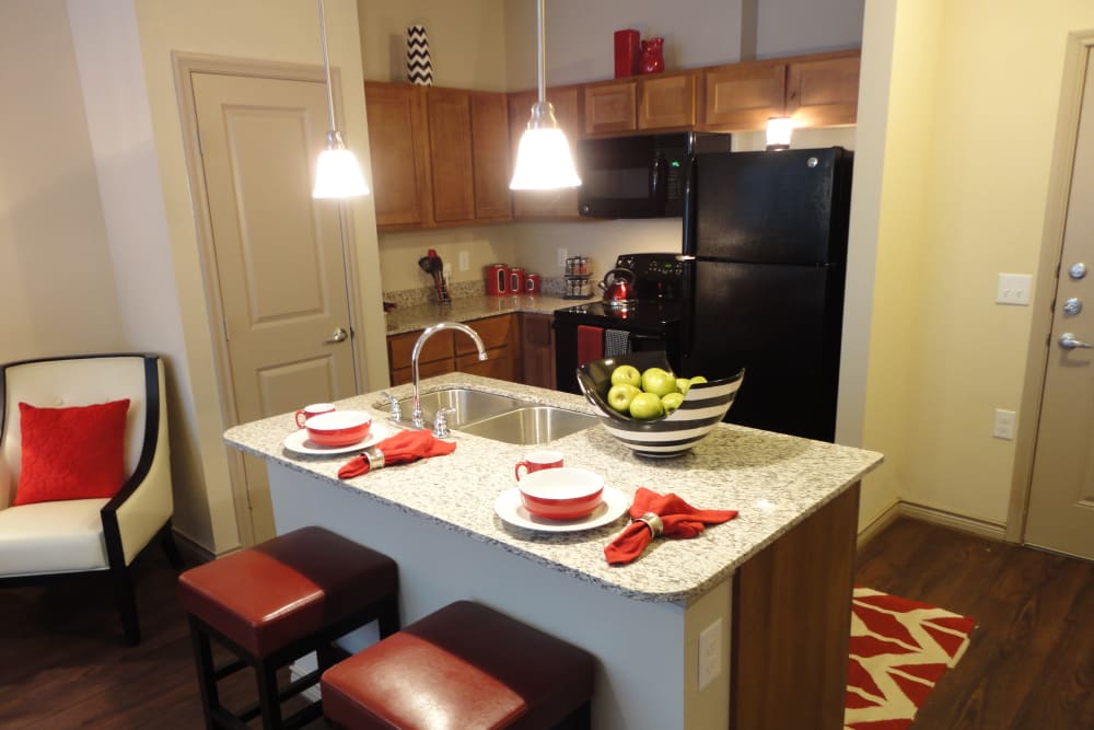Kitchen with island seating at Anatole at City View in Lubbock, Texas