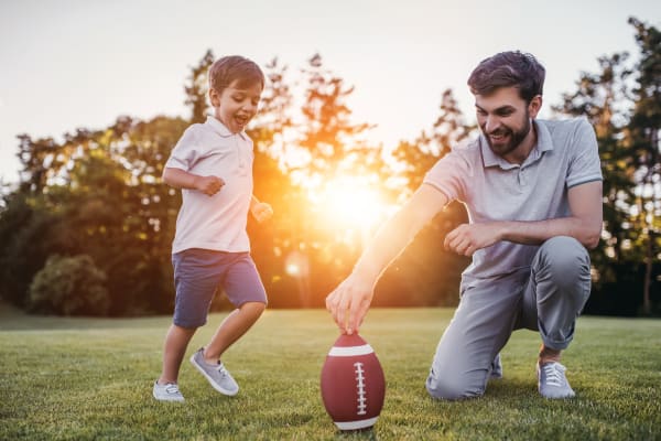 Father and son playing football at Aviara at Mountain House in Mountain House, California