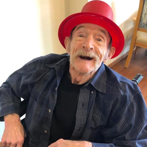 An excited resident wearing a red bucket cap Ashbrook Village in Duncan, Oklahoma