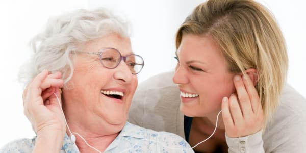 Resident and caretaker listening to their favorite song at The Residences on Forest Lane in Montello, Wisconsin