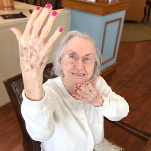 Resident showing off her painted nails at Oxford Glen Memory Care at Grand Prairie in Grand Prairie, Texas